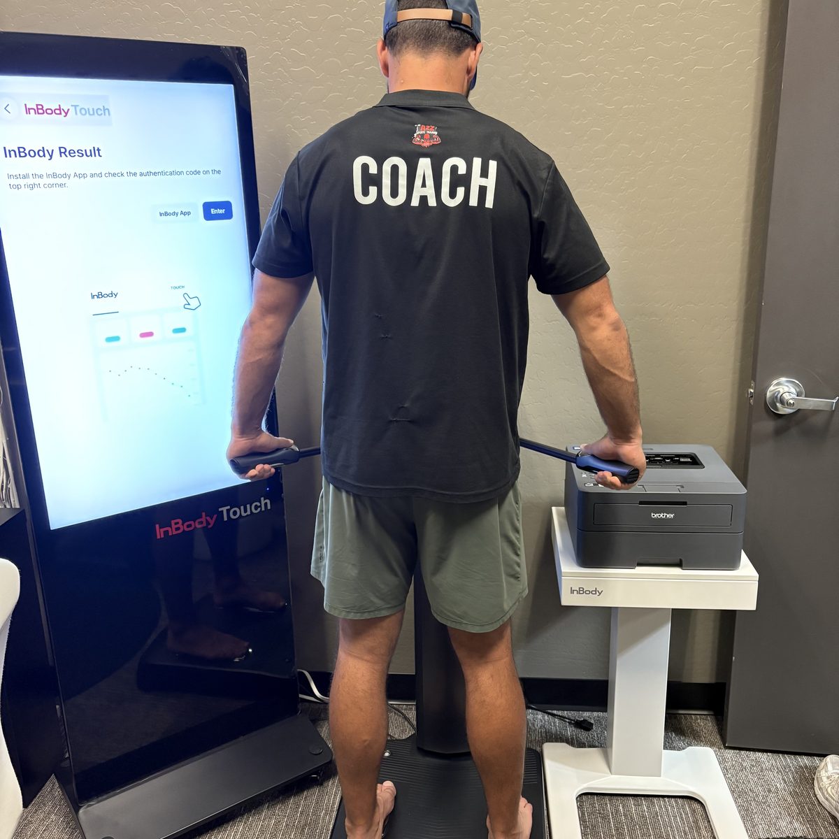 Coach doing an InBody body composition scan at A2Z Sports Training in Mesa, AZ