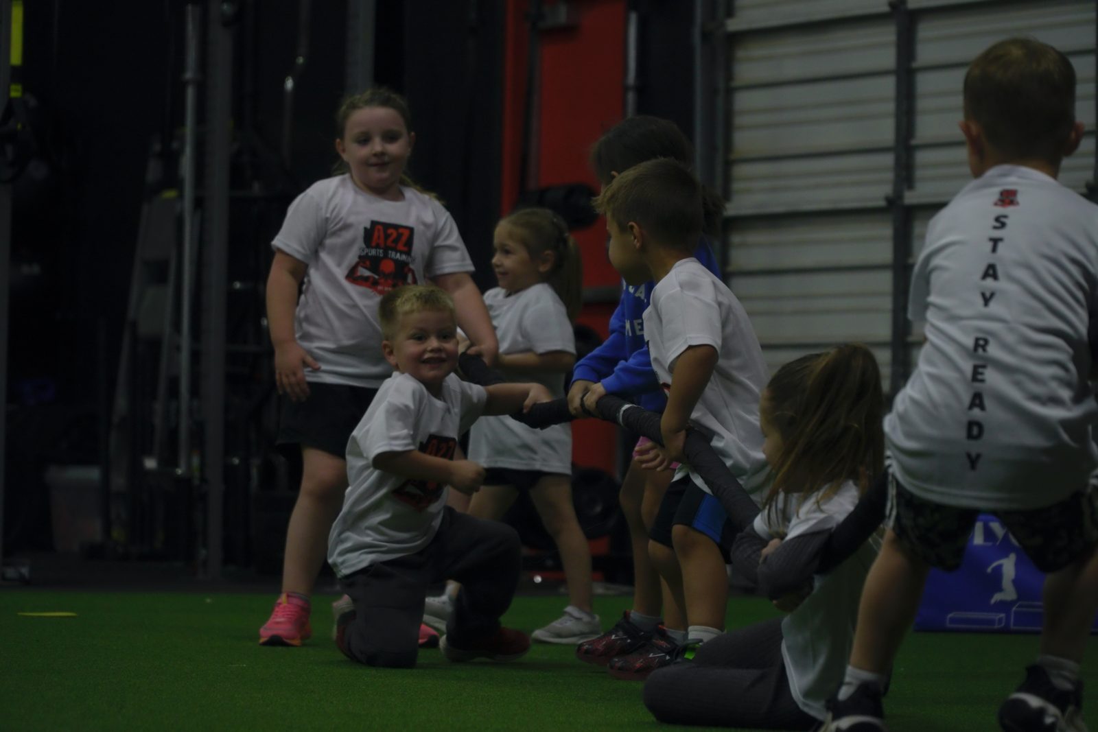 Kids working through a group exercise on the indoor turf at A2Z Sports Training
